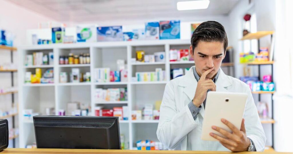 concerned pharmacy director looking at computer