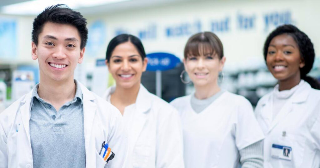 smiling pharmacy team in retail setting