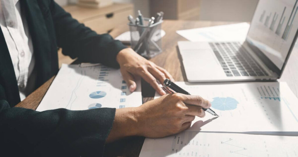 closeup of professional at desk looking at future graphs