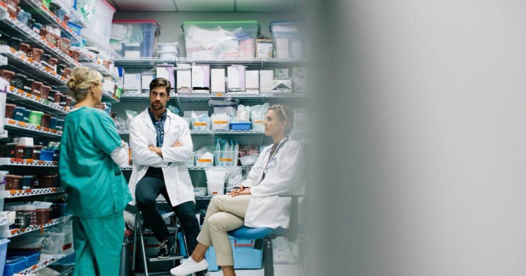 three pharmacy professionals in office having discussion