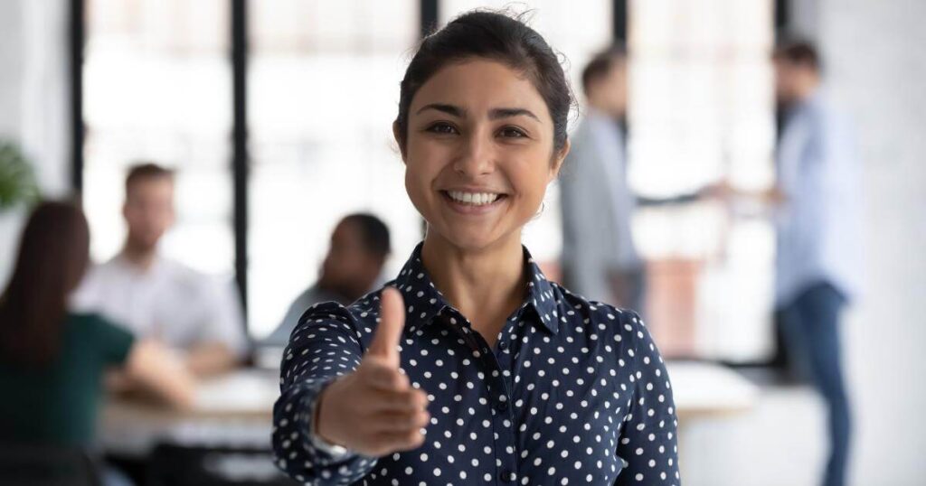 smiling recruiter with extended hand 