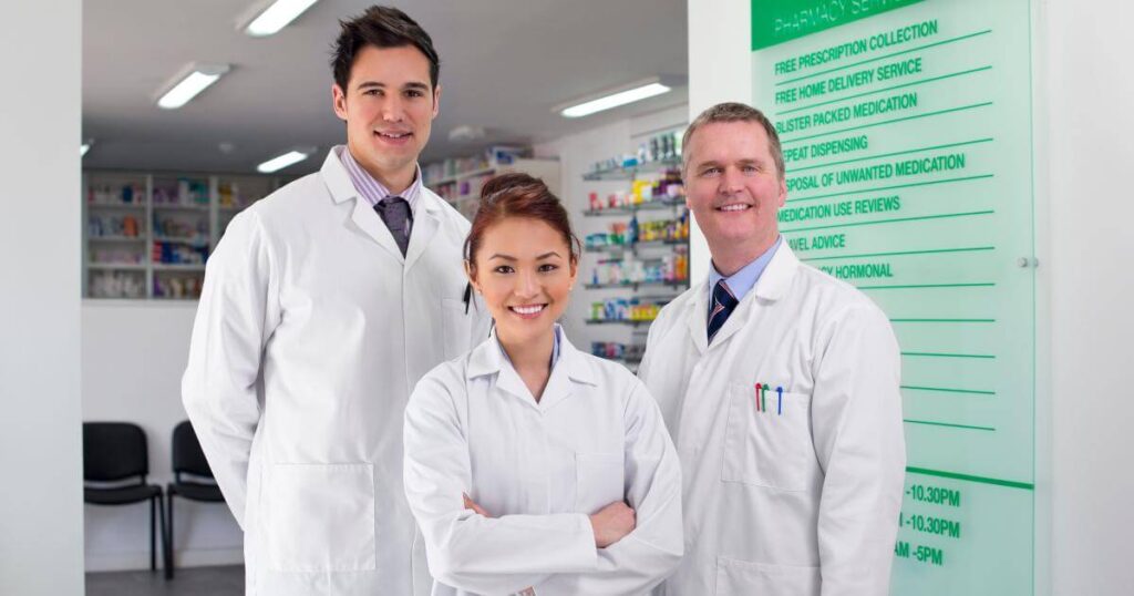 hospital pharmacy staff smiling at camera